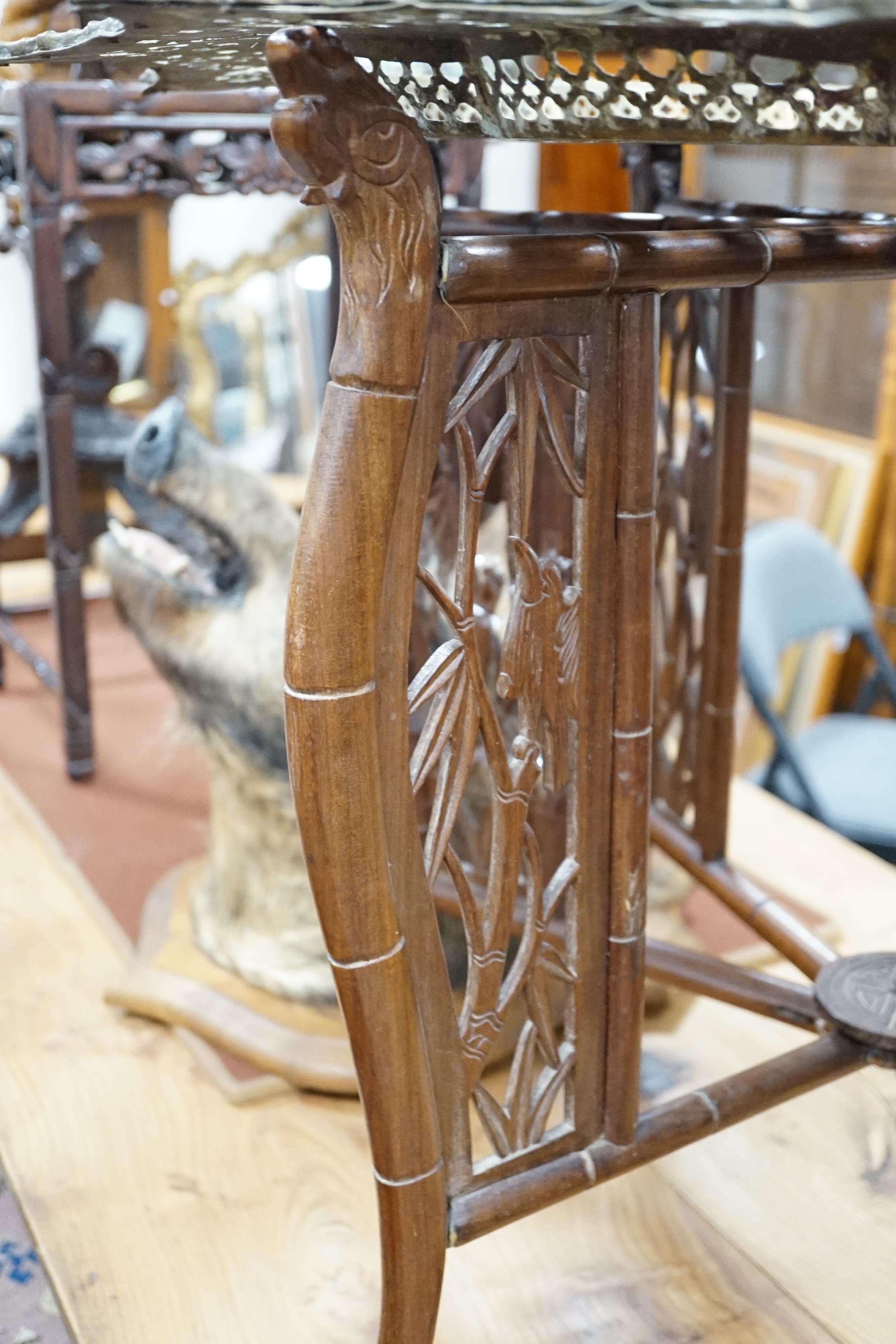 A Chinese circular fretted brass topped folding occasional table, diameter 82cm, height 62cm